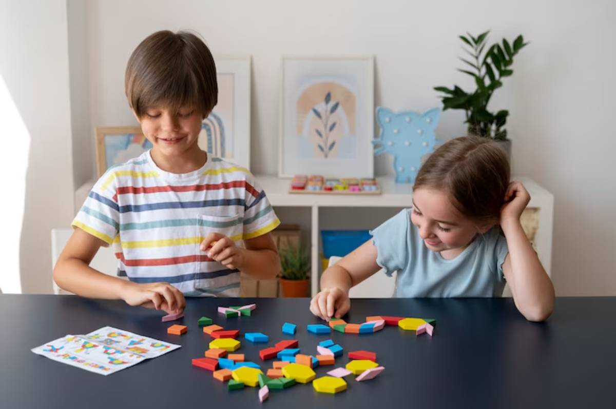 Two children play with colorful building blocks on a table, surrounded by vibrant artwork and plants in a well-lit room.